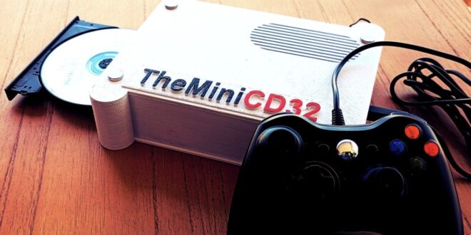 A gaming console with a controller and CD.