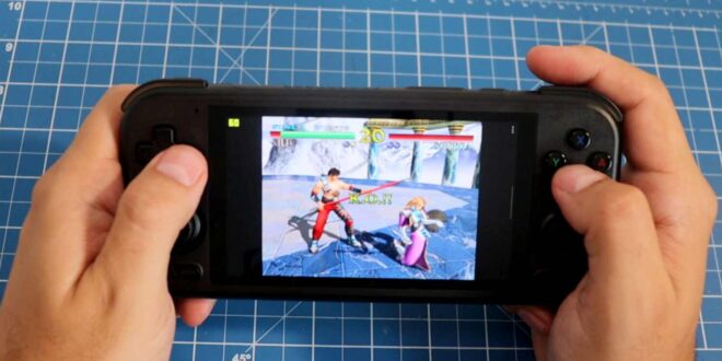 Person playing a fighting game on handheld console.