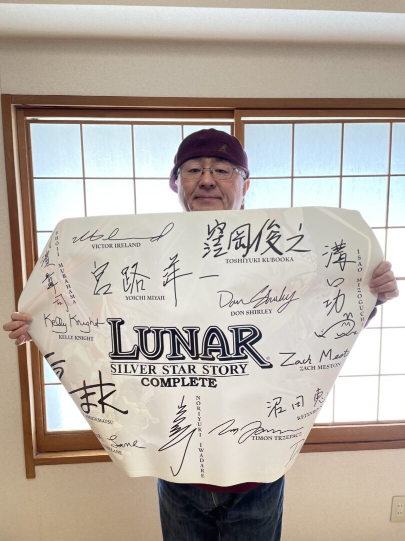 Person holding signed Lunar game poster