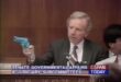 Senator Joe Lieberman holds up a light gun revolver from Konami's "Lethal Enforcers" game