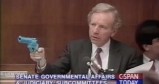 Senator Joe Lieberman holds up a light gun revolver from Konami's "Lethal Enforcers" game