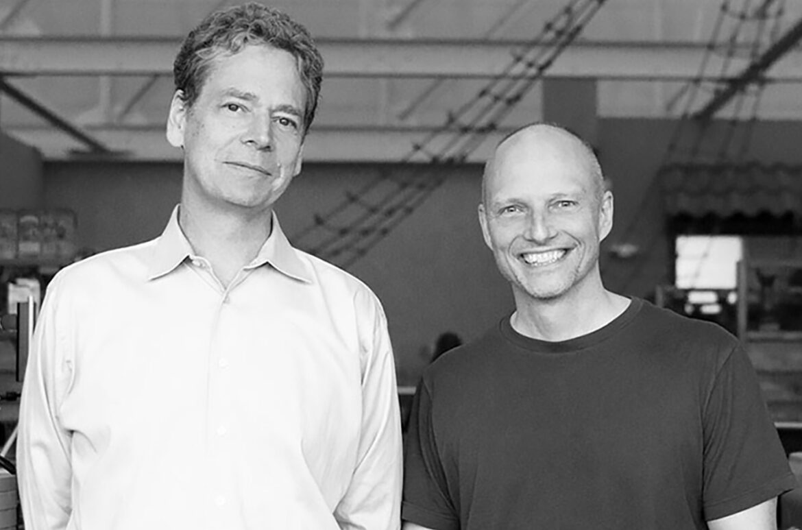 Two smiling men in a casual setting.