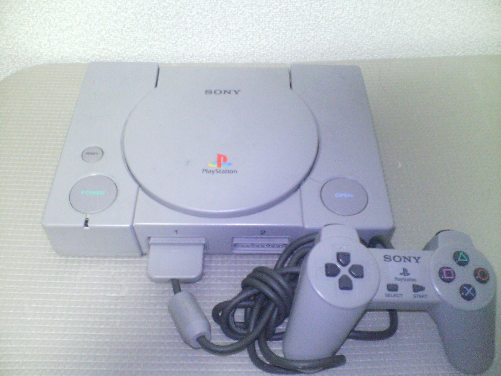 PlayStation console SCPH-5500 and PlayStation Controller.