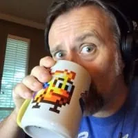 Portrait of Iguana artist Jools Watsham holding a pixel-art mug