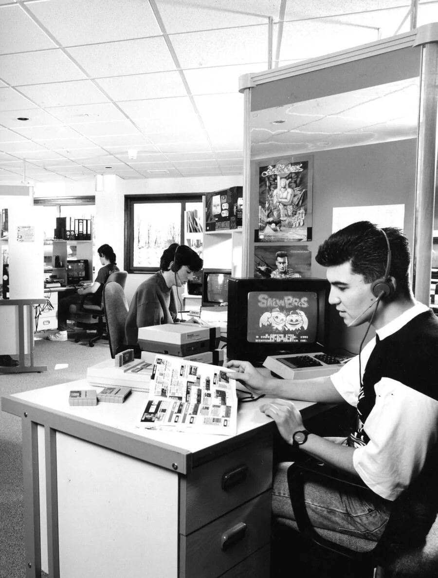 British Nintendo hotline counselors work at desks with NES consoles and headsets