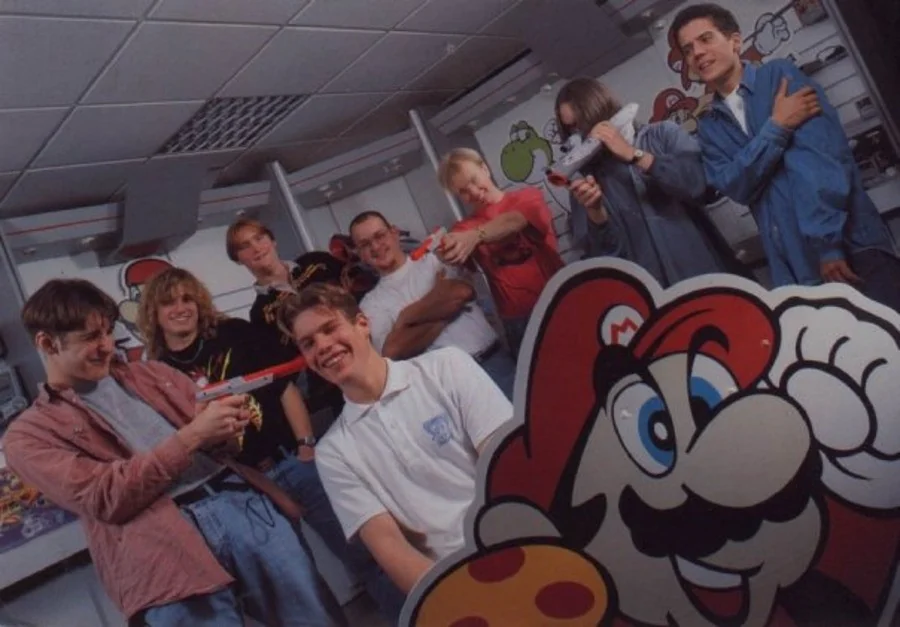 Keith Pullin and British Nintendo hotline colleagues pose around supervisor Ben Gunstone and a Mario cutout in 1993