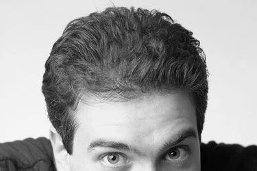 Black and white portrait of former Xbox executive Kevin Bachus