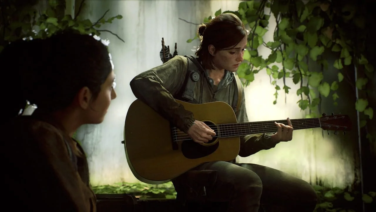 Ellie plays guitar beside Dina in The Last of Us Part II