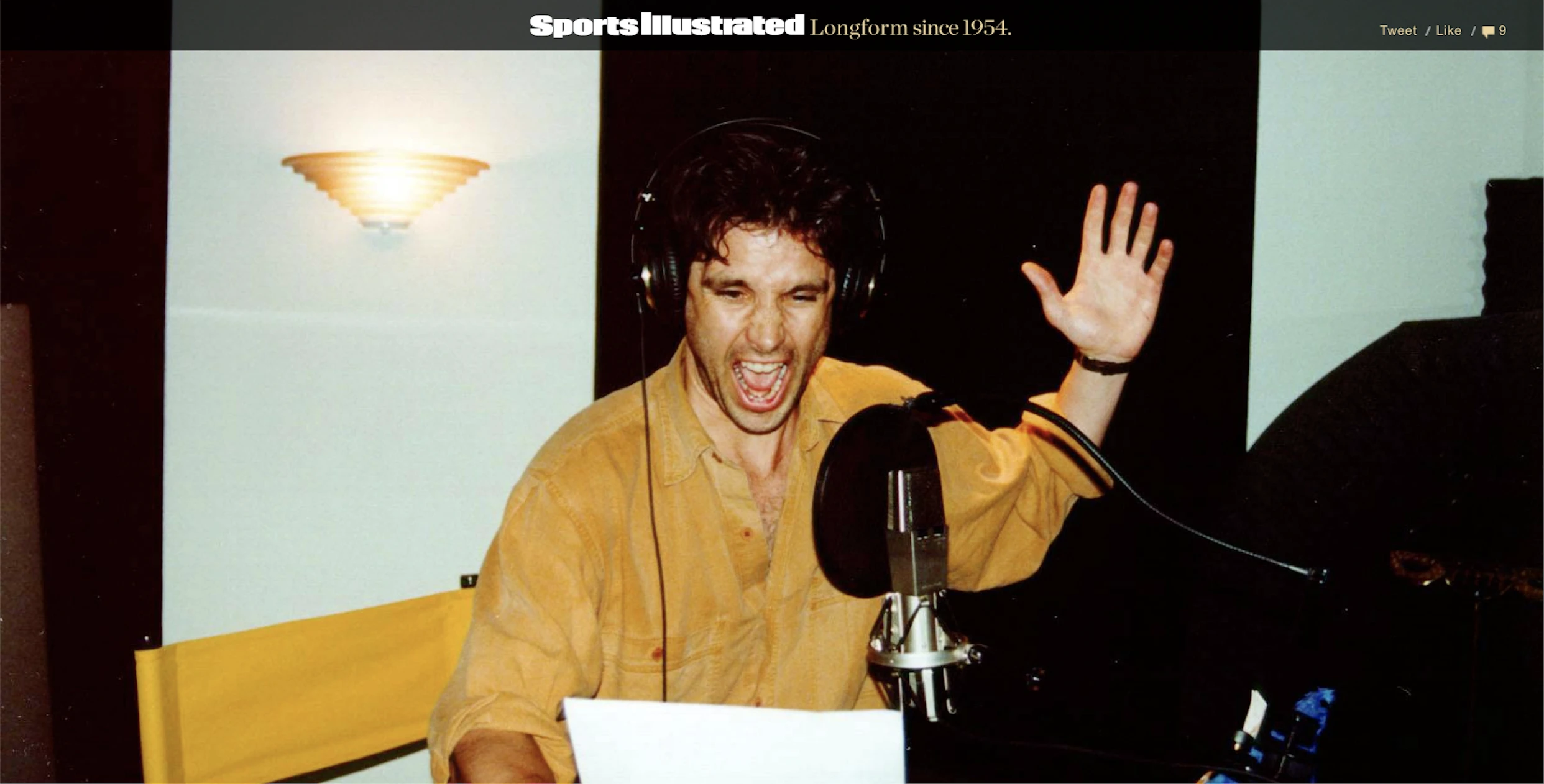 Archival image of Tim Kitzrow wearing headphones and performing at a studio microphone