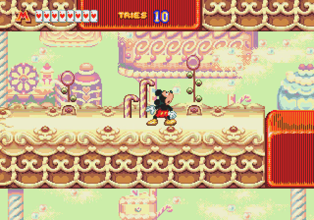 Mickey navigates a bright confectionery-themed stage.